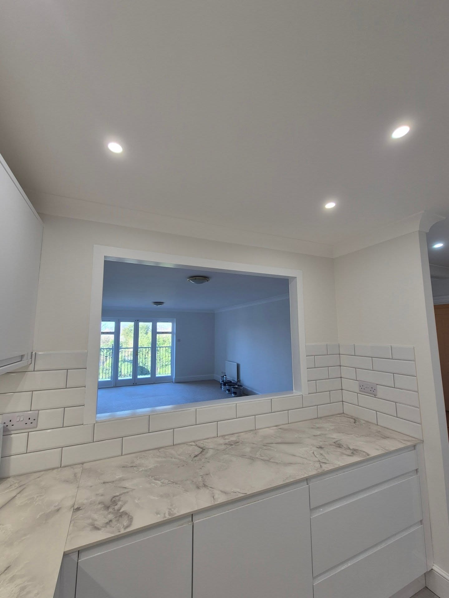 Kitchen with marble countertop and subway tiles by Faughnan and Sons